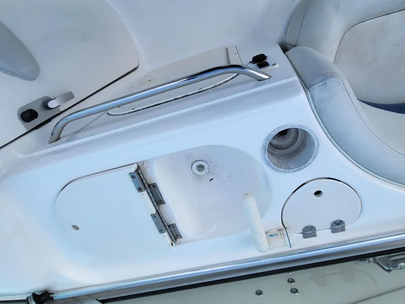 Slide: The Image of 2002 Chaparral Sunesta 233 boat interior with sink and seating area. - 22