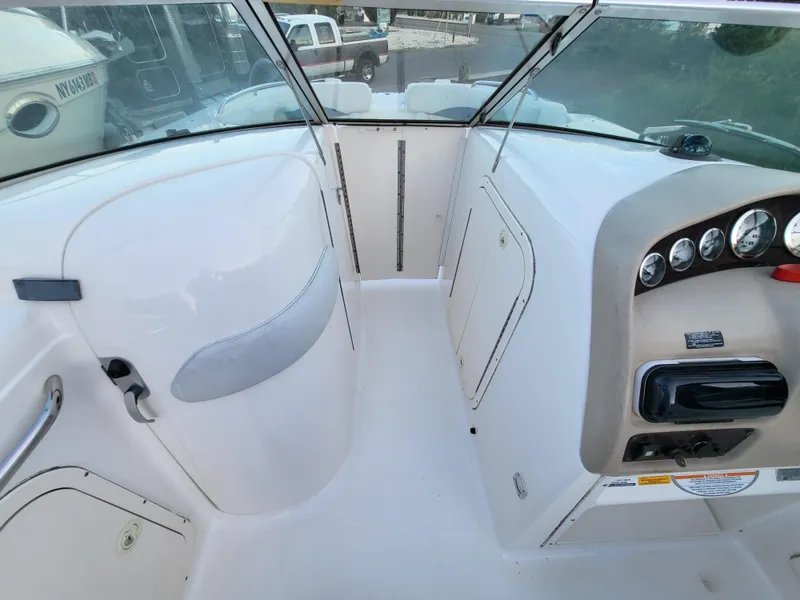 Slide: The Image of 2002 Chaparral Sunesta 233 boat interior with dashboard and seating area. - 25