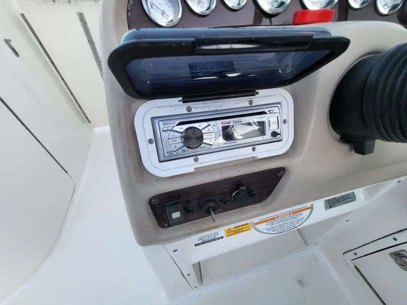 Slide: The Image of 2002 Chaparral Sunesta 233 dashboard with stereo system and control panel. - 27