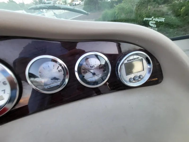Slide: The Image of Dashboard of a 2002 Chaparral Sunesta 233 boat with gauges and a Humminbird display. - 29