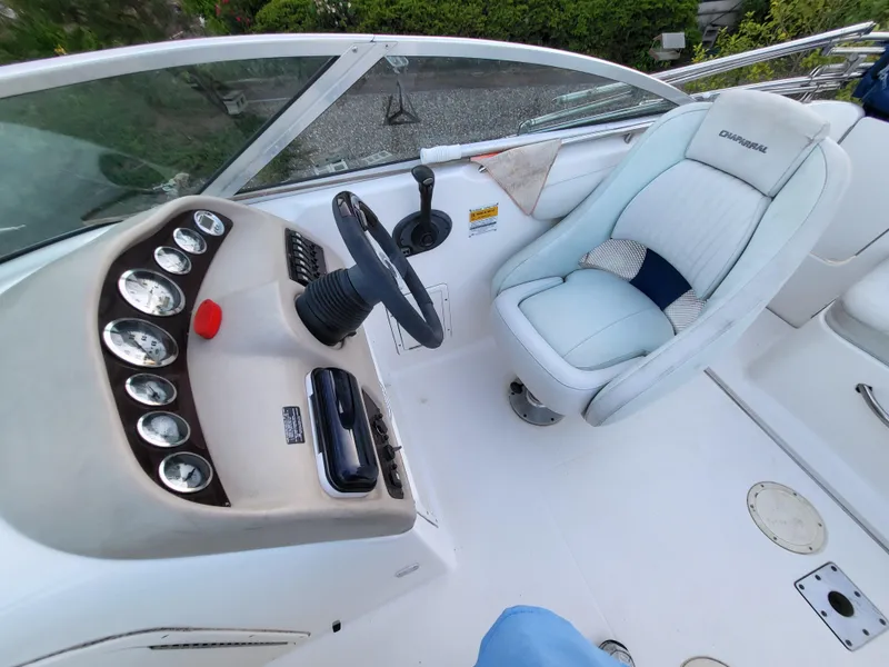 Slide: The Image of 2002 Chaparral Sunesta 233 boat cockpit with steering wheel and cushioned seat. - 3