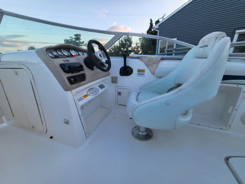 Slide: The Image of 2002 Chaparral Sunesta 233 boat interior with steering wheel and captain's chair. - 31