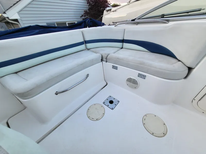 Slide: The Image of 2002 Chaparral Sunesta 233 boat interior with white and blue seating. - 33