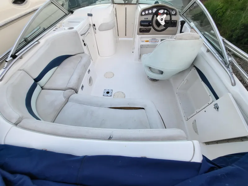 Slide: The Image of 2002 Chaparral Sunesta 233 boat interior with seating and steering console. - 34