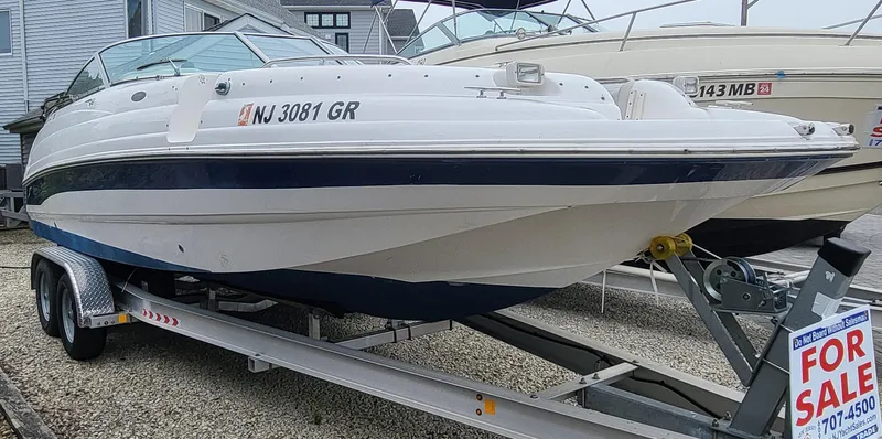 Slide: The Image of 2002 Chaparral Sunesta 233 boat on trailer, for sale sign visible. - 7