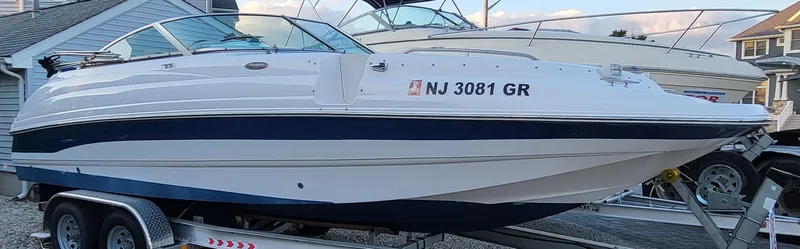 Slide: The Image of 2002 Chaparral Sunesta 233 boat on trailer, side view, white and blue design. - 8