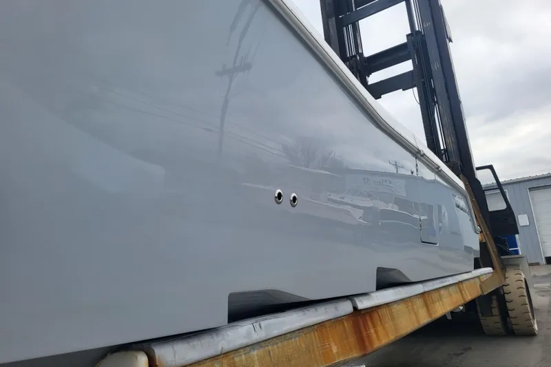 Slide: The Image of 2024 Invincible 36 boat hull on a forklift for transport. - 5