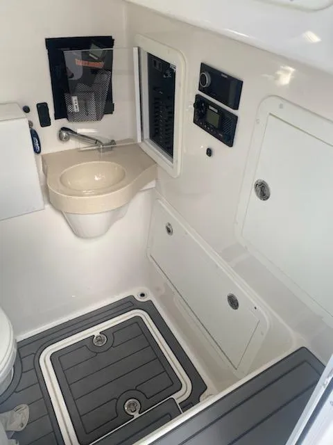 Slide: The Image of 2019 Invincible 39 Open Fisherman boat interior with sink and control panel. - 19
