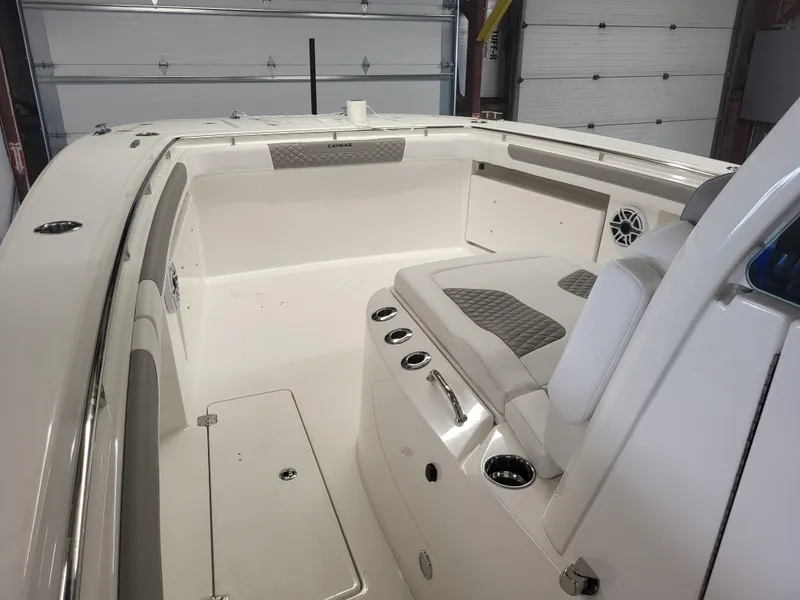 Slide: The Image of 2024 Caymas 34 CT boat interior with seating and storage compartments. - 11