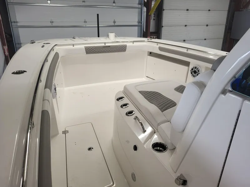 Slide: The Image of 2024 Caymas 34 CT boat interior with seating and storage compartments. - 12