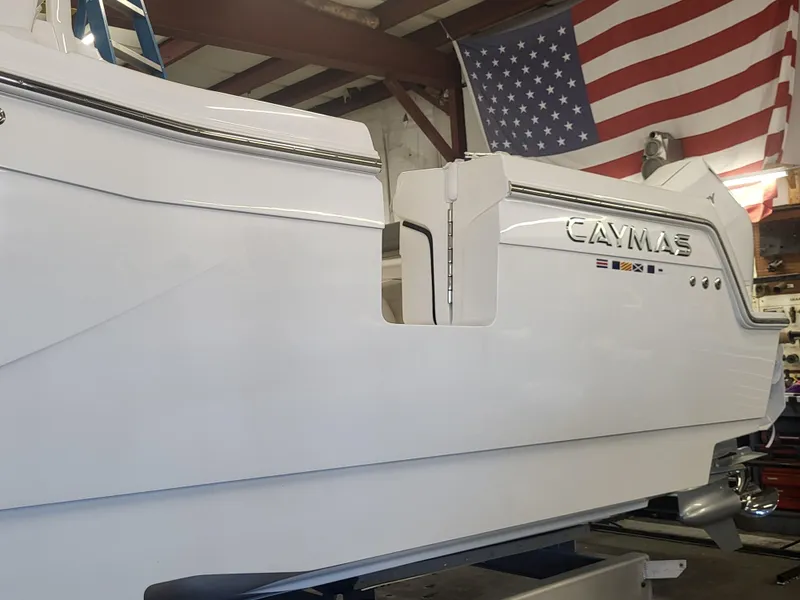 Slide: The Image of 2024 Caymas 34 CT boat in a showroom with American flag. - 13