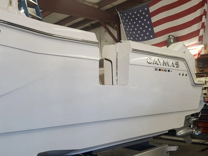 Slide: The Image of 2024 Caymas 34 CT boat in a workshop with American flag. - 14