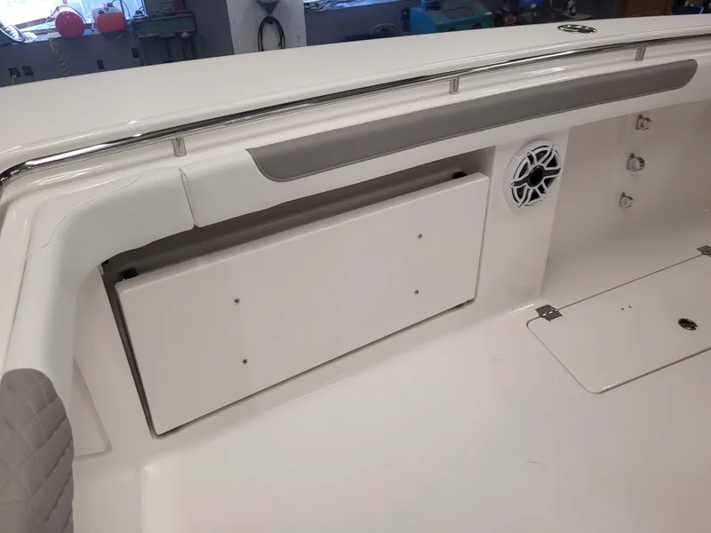 Slide: The Image of 2024 Caymas 34 CT boat interior with storage compartment and speaker. - 15