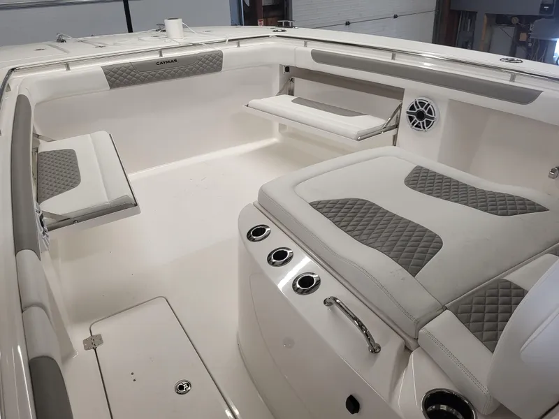 Slide: The Image of 2024 Caymas 34 CT boat interior with cushioned seating and storage compartments. - 16
