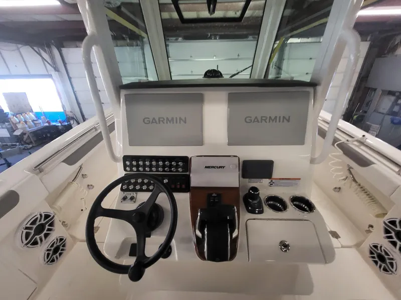 Slide: The Image of 2024 Caymas 34 CT boat helm with dual Garmin displays and Mercury controls. - 23