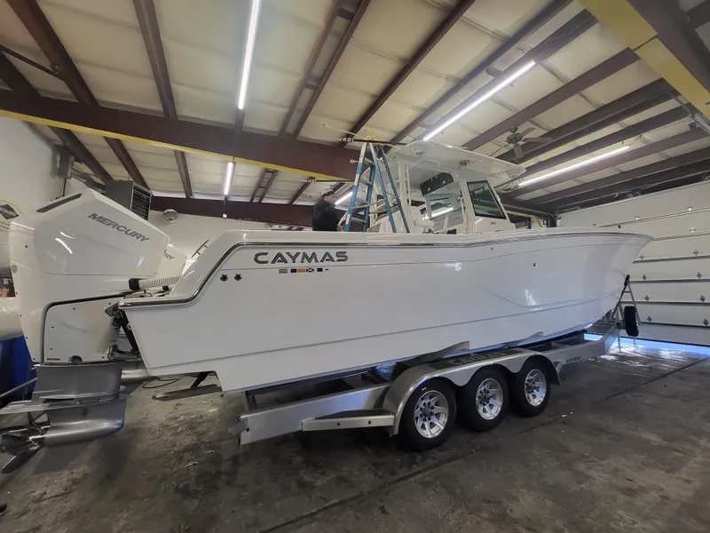 Slide: The Image of 2024 Caymas 34 CT boat on a trailer in a warehouse. - 3