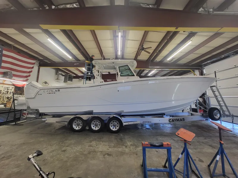 Slide: The Image of 2024 Caymas 34 CT boat on trailer in a garage. - 4
