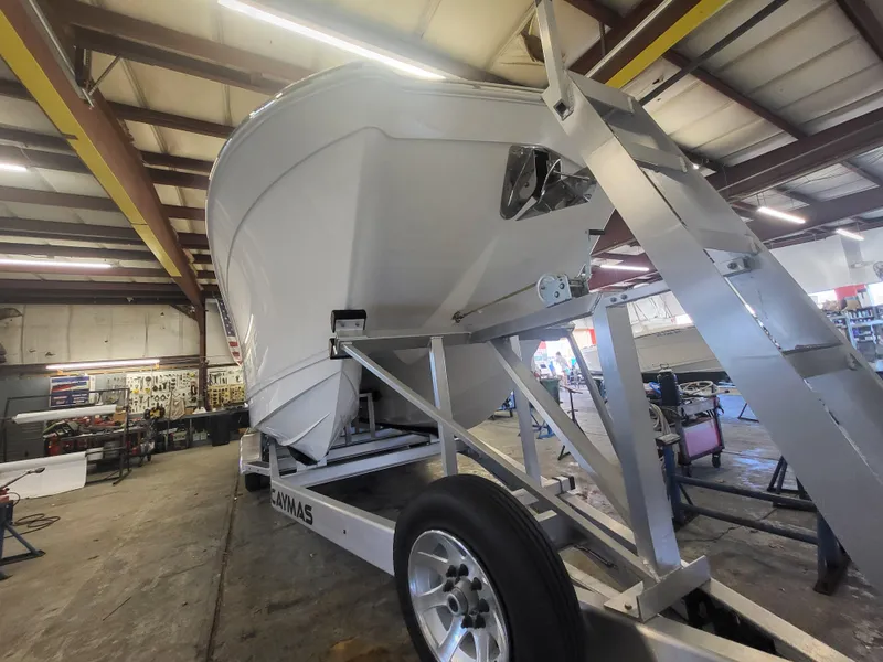 Slide: The Image of 2024 Caymas 34 CT boat on trailer in a workshop. - 5