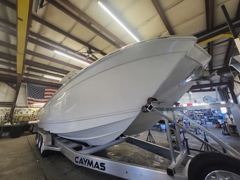 Slide: The Image of 2024 Caymas 34 CT boat on a trailer in a warehouse. - 6