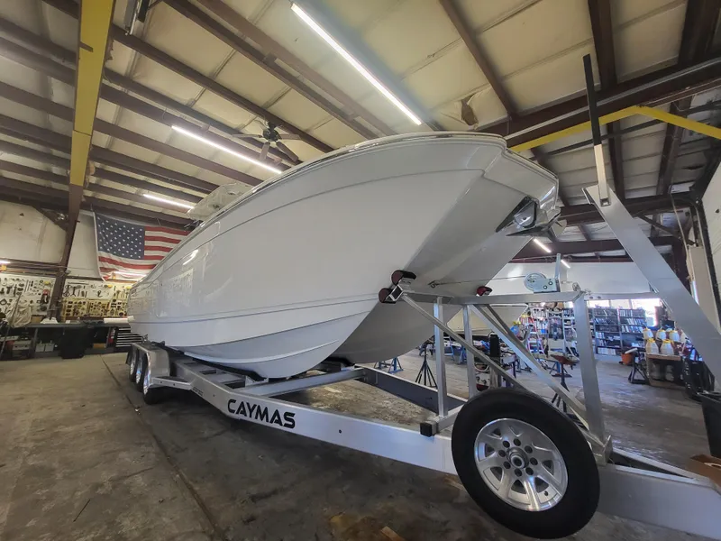 Slide: The Image of 2024 Caymas 34 CT boat on trailer in a warehouse. - 9