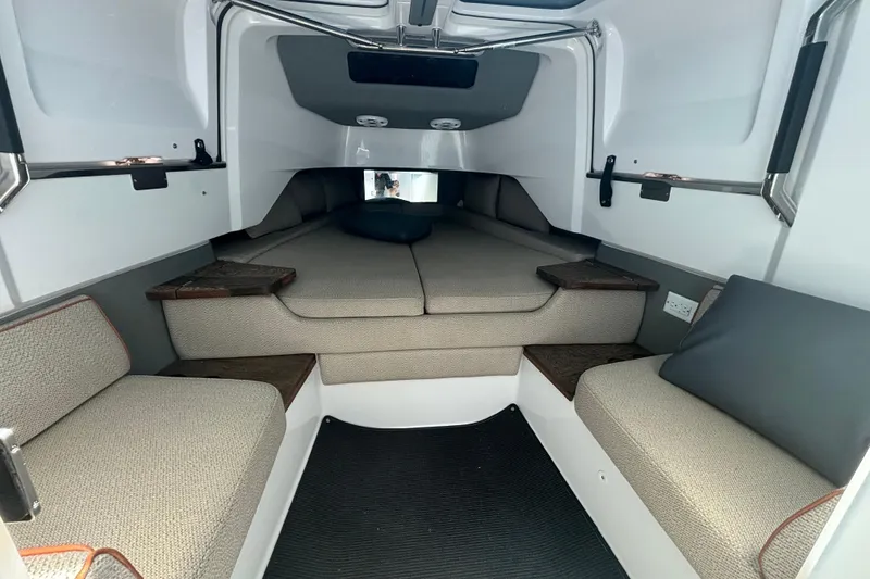 Slide: The Image of 2020 Axopar 37 XC Cross Cabin interior with cushioned seating and modern design. - 24