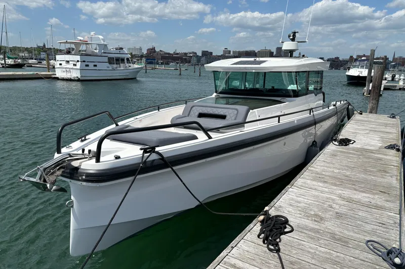Slide: The Image of 2020 Axopar 37 XC boat docked at a marina on a sunny day. - 32