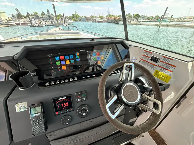 Slide: The Image of Helm of 2020 Axopar 37 XC with advanced navigation system and steering wheel. - 4
