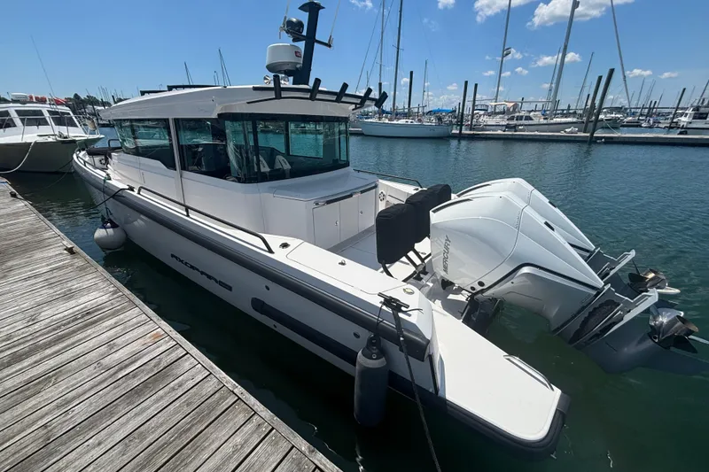 Slide: The Image of 2020 Axopar 37 XC Cross Cabin docked at marina with twin Mercury engines. - 38
