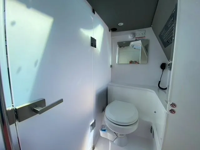 Slide: The Image of 2020 Axopar 37 XC boat bathroom with toilet and mirror. - 15
