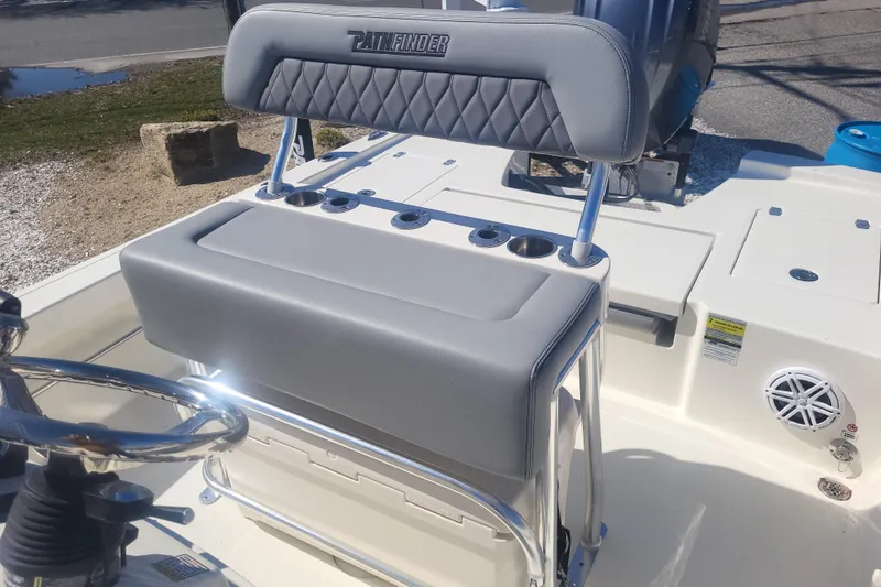 Slide: The Image of 2024 Pathfinder 2200 TRS boat interior with steering wheel and seating detail. - 14