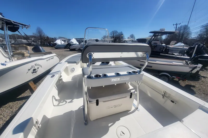 Slide: The Image of 2024 Pathfinder 2200 TRS boat with center console, docked outdoors under clear blue sky. - 16