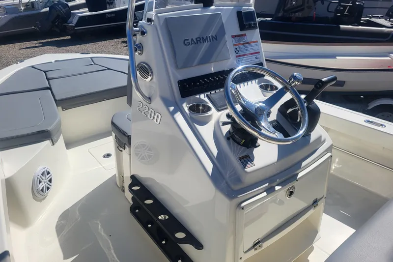 Slide: The Image of 2024 Pathfinder 2200 TRS boat interior with Garmin navigation and steering wheel. - 17