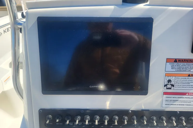 Slide: The Image of Garmin screen and switches on Pathfinder 2200 TRS 2024 boat. - 18