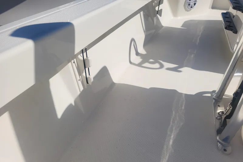 Slide: The Image of 2024 Pathfinder 2200 TRS boat interior with clean white deck and seating area. - 19