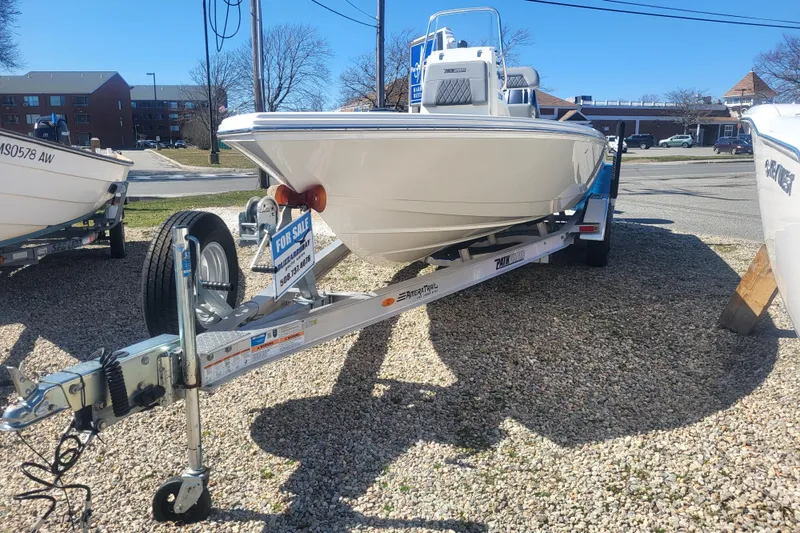 Slide: The Image of 2024 Pathfinder 2200 TRS boat on trailer, for sale in outdoor lot. - 2