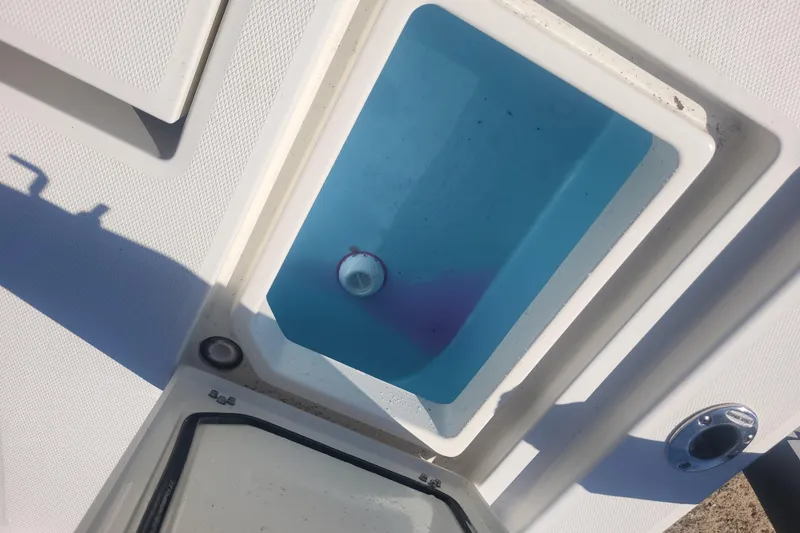 Slide: The Image of Livewell compartment on a 2024 Pathfinder 2200 TRS boat, featuring a blue interior. - 22