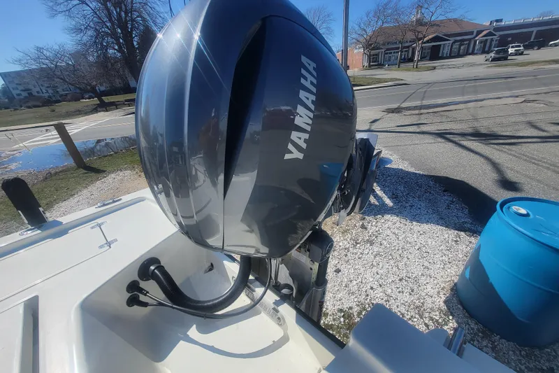 Slide: The Image of 2024 Pathfinder 2200 TRS boat with Yamaha outboard motor in a sunny outdoor setting. - 25