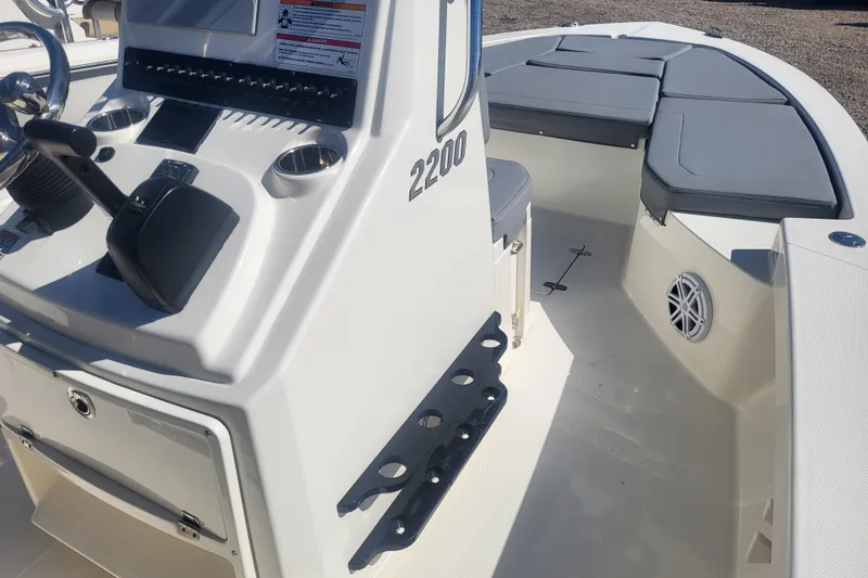 Slide: The Image of 2024 Pathfinder 2200 TRS boat interior with steering console and seating area. - 28