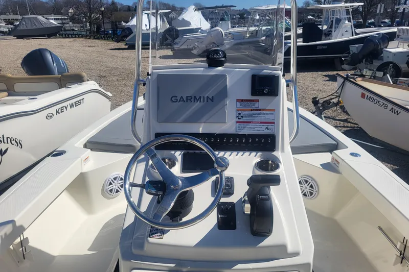 Slide: The Image of 2024 Pathfinder 2200 TRS boat console with Garmin navigation system and steering wheel. - 6