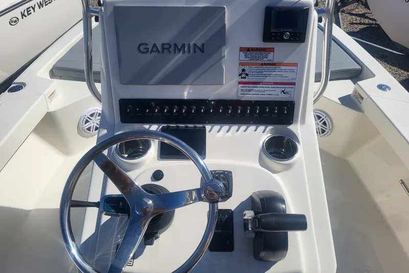 Slide: The Image of 2024 Pathfinder 2200 TRS boat console with Garmin display and steering wheel. - 7