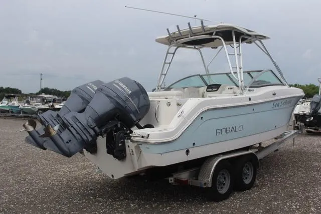 Slide: The Image of 2015 Robalo R247 boat on trailer with twin Yamaha outboard engines. - 4