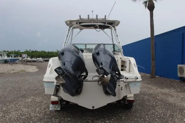 Slide: The Image of 2015 Robalo R247 boat with dual outboard motors, rear view. - 5