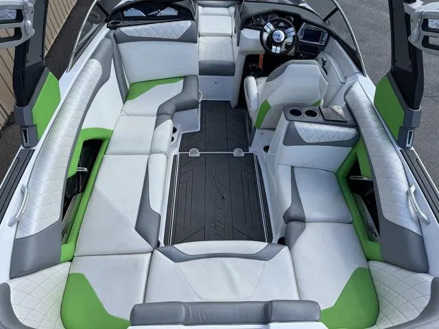 Slide: The Image of 2017 Tigé Z3 boat interior with white, gray, and green seating, featuring a modern dashboard. - 4