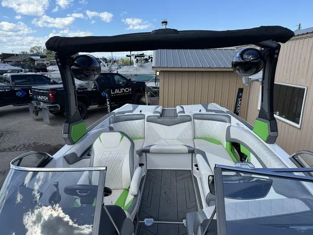 Slide: The Image of 2017 Tigé Z3 boat interior with white and green seating, open cockpit, and tower speakers. - 5