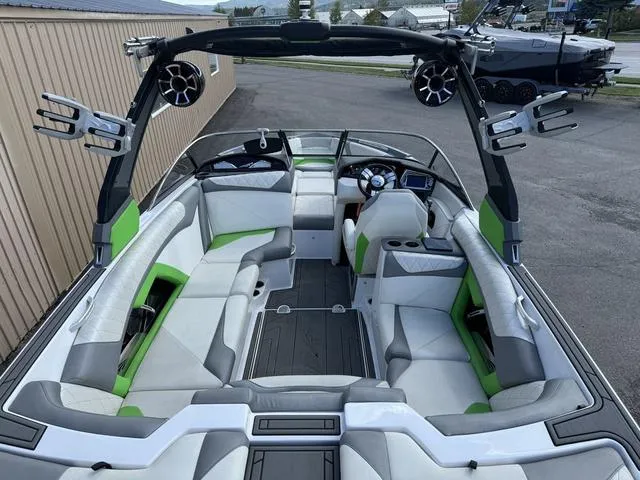 Slide: The Image of 2017 Tigé Z3 boat interior with green accents and spacious seating. - 7