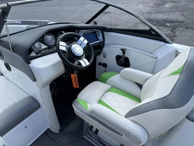 Slide: The Image of 2017 Tigé Z3 boat interior with modern dashboard and green-accented seating. - 9