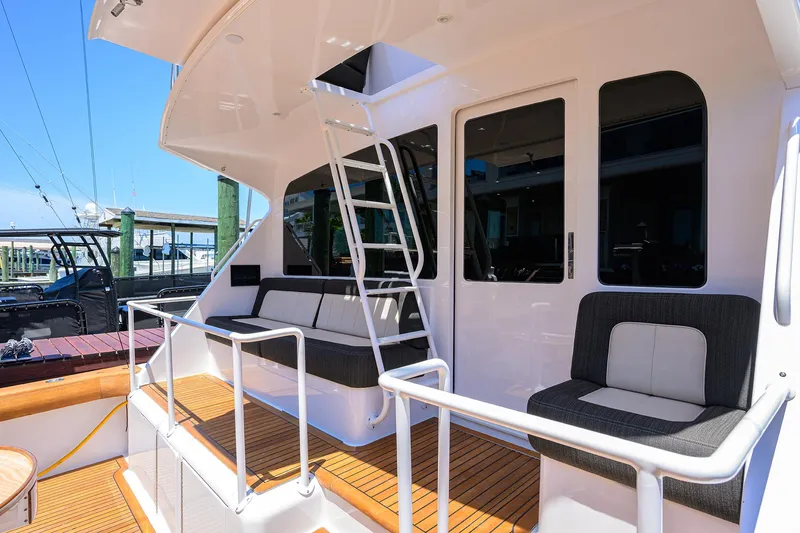 Slide: The Image of 2004 Viking 65 Enclosed Bridge w/Tower yacht deck with seating and ladder. - 11