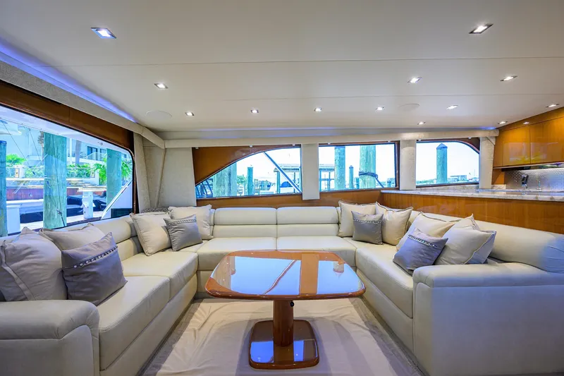 Slide: The Image of Luxurious interior of 2004 Viking 65 Enclosed Bridge yacht with plush seating and wooden table. - 15