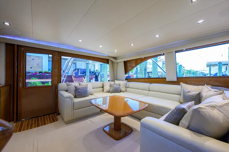 Slide: The Image of Luxurious interior of 2004 Viking 65 Enclosed Bridge yacht with plush seating and wooden table. - 16