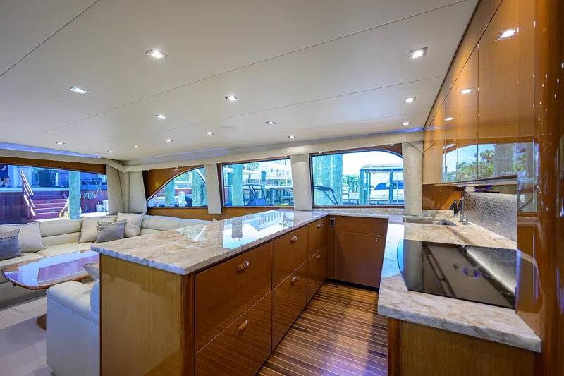 Slide: The Image of Luxurious interior of 2004 Viking 65 Enclosed Bridge yacht with modern kitchen and seating area. - 18